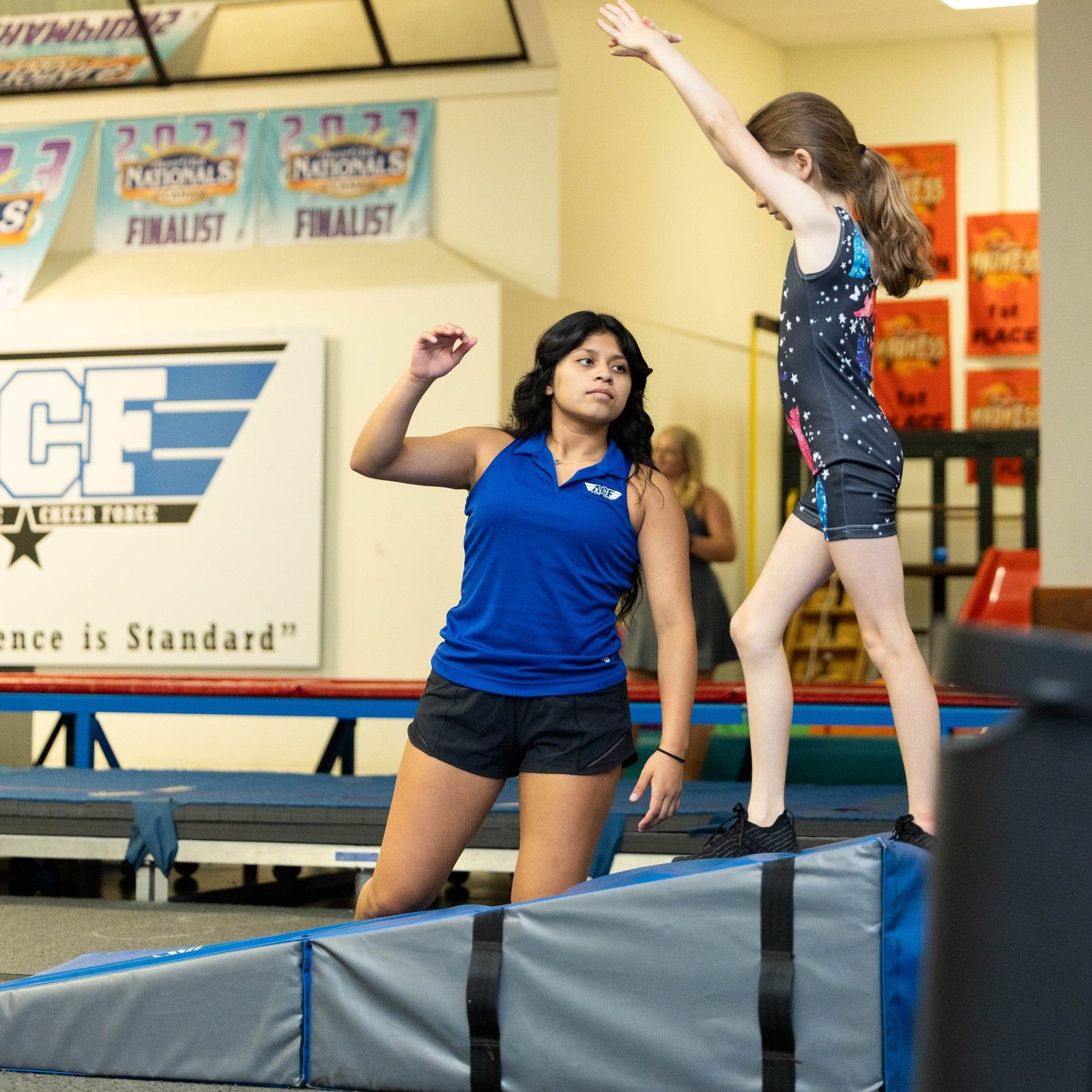 ACF-142 Student learning front flips during classes at ACF